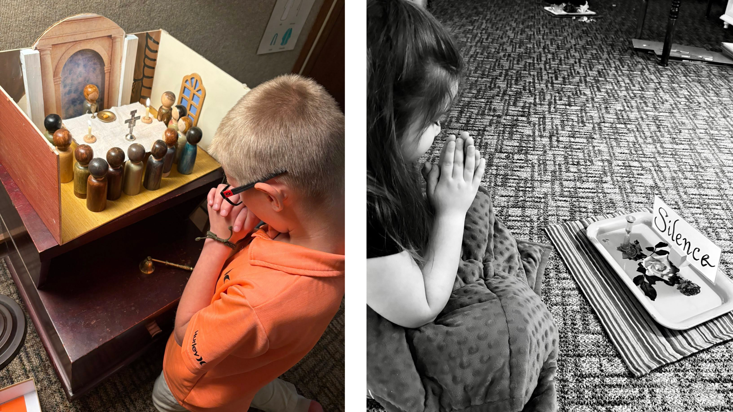 Child in an orange shirt sits beside a wooden nativity display, looking down at the figures with hands near his face.